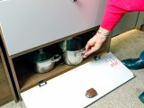 Pans can be accommodated in this shelved cupboard