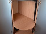 This deep, shelved cupboard opens beneath the circular sink