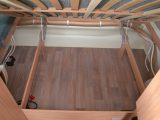 The fixed bed's slats hold themselves up and reveal this large storage cavity