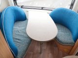 The quirky front dinette is set at a slant, for a bit more room, and the settees have ample curved backs