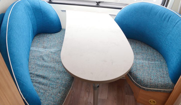 The quirky front dinette is set at a slant, for a bit more room, and the settees have ample curved backs