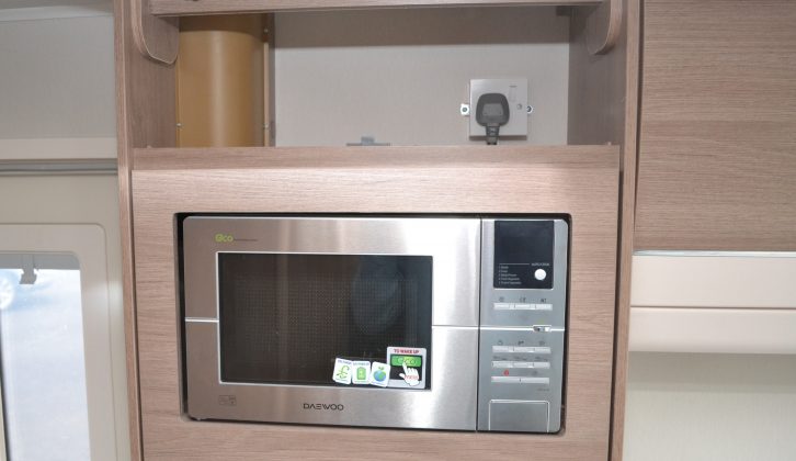 The microwave is above the sideboard, separated from the main kitchen
