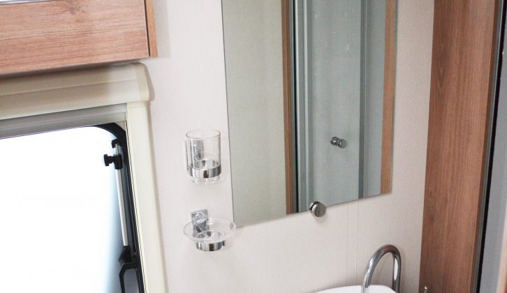 There's a good-sized mirror behind the sink, but that towel ring is quite high!