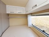 The 1.87 x 1.28/80m French bed has a large window with a blind and domestic-style curtains, as well as overhead lockers, a shelf and two adjustable reading lights