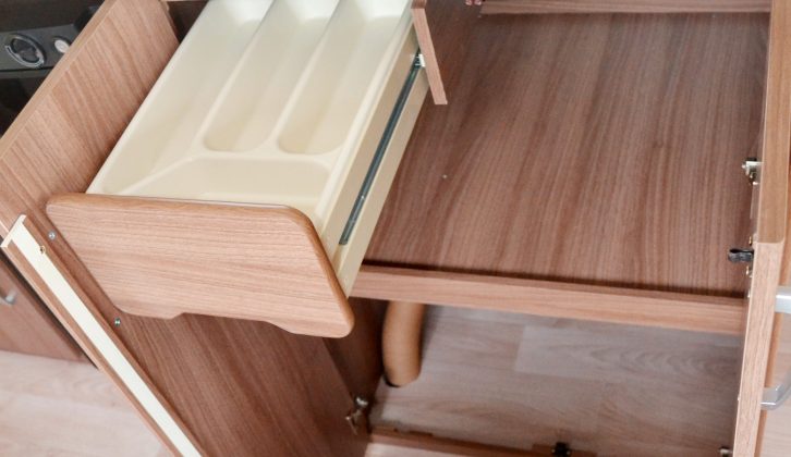 You'll find a large, shelved cupboard and this cutlery drawer beneath the kitchen worktop