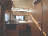 Rearwards view in the Eriba Touring Troll 530 '60 Edition' showing the offside galley and nearside washroom leading on to the fixed double bed in the rear
