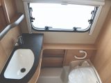 Multi-function washroom in the Eriba Touring Troll 530 '60 Edition' comprises a bench toilet and a vanity unit. The washroom floor forms the shower tray.