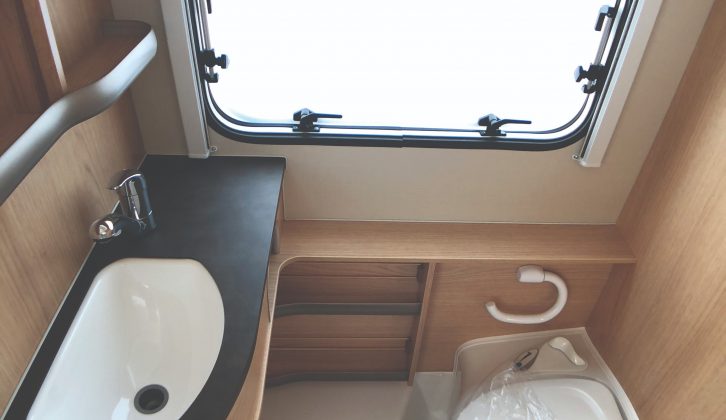 Multi-function washroom in the Eriba Touring Troll 530 '60 Edition' comprises a bench toilet and a vanity unit. The washroom floor forms the shower tray.