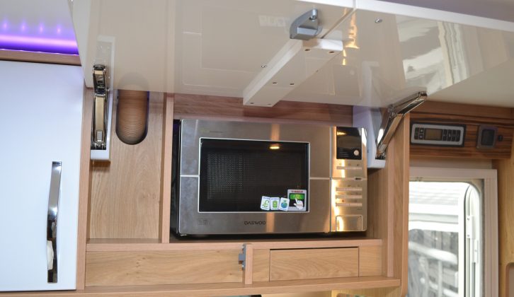 An overhead cupboard door hides the microwave