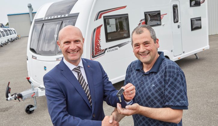 Elliot Hibbs presents competition winner Gary Walker with the keys to his brand new Coachman Vision 580