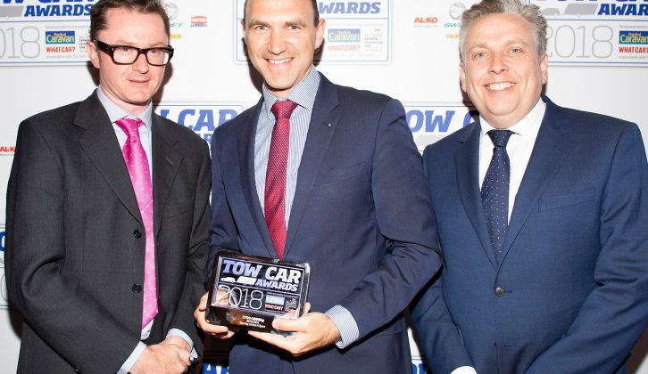 BMW's Brian Cox collects the award for the best car weighing 1700-1899kg - the BMW 5 Series Touring - in the Tow Car Awards 2018, from Practical Caravan's editor, Niall Hampton, and co-host James Cannon