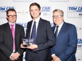 Land Rover's Matt Ellis collects the award for the best car weighing 1900kg+ - the Land Rover Discovery - in the Tow Car Awards 2018, from Practical Caravan's editor, Niall Hampton, and co-host James Cannon