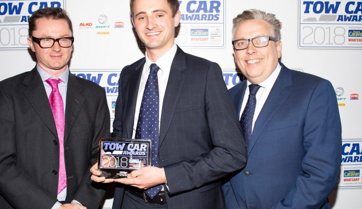 Land Rover's Matt Ellis collects the award for the best car weighing 1900kg+ - the Land Rover Discovery - in the Tow Car Awards 2018, from Practical Caravan's editor, Niall Hampton, and co-host James Cannon