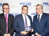 Kia's Steve Hicks collects the Best Petrol Tow Car award for the Kia Stinger at the Tow Car Awards 2018, from Practical Caravan's editor, Niall Hampton, and co-host James Cannon