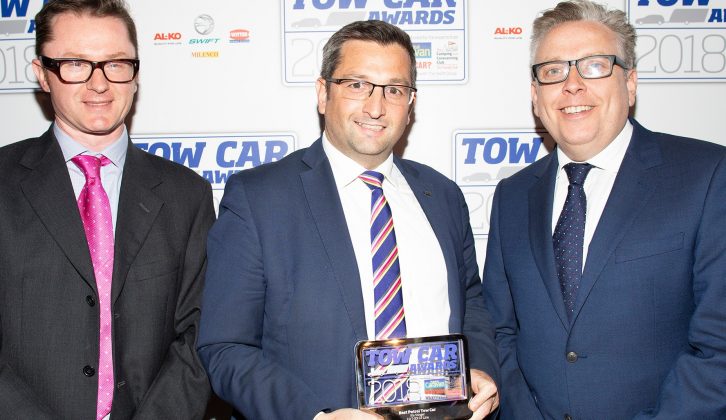 Kia's Steve Hicks collects the Best Petrol Tow Car award for the Kia Stinger at the Tow Car Awards 2018, from Practical Caravan's editor, Niall Hampton, and co-host James Cannon