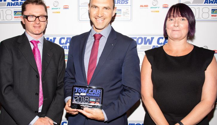 BMW's Brian Cox returns to the stage to collect the award for Tow Car of the Year - the BMW 5 Series Touring - at the Tow Car Awards 2018, from Practical Caravan's editor, Niall Hampton, and Sabina Voysey from the Camping and Caravanning Club