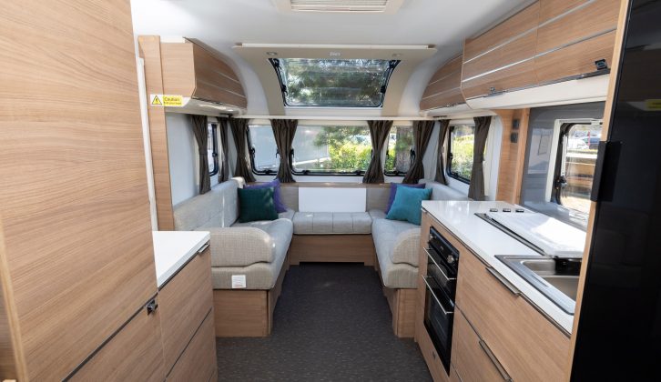 The van features a u-shaped lounge with a fold-down table for putting drinks on