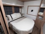 The master bedroom of the Coachman Laser 650 features an offside-mounted transverse island bed with a recess in the back wall for hanging a flatscreen TV