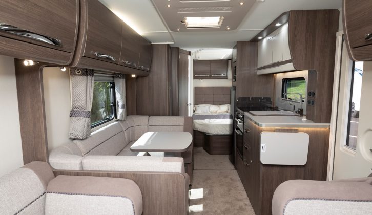 Looking towards the rear in the Buccaneer Aruba, there's a high-specification midships kitchen with cast iron pan stands on the cooker, and a dinette that doubles as a make-up bed