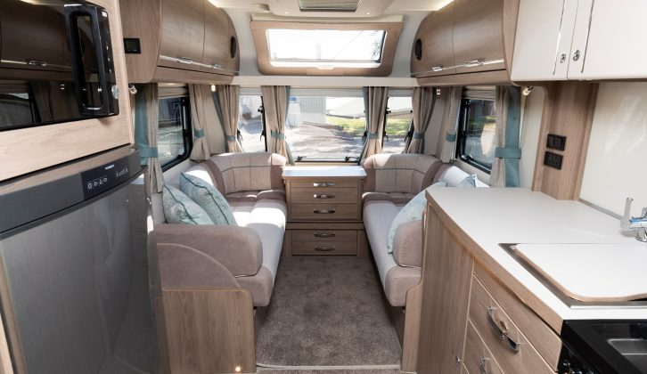 A well-equipped kitchen overlooks the comfortable front lounge in the 2019 Compass Camino 674