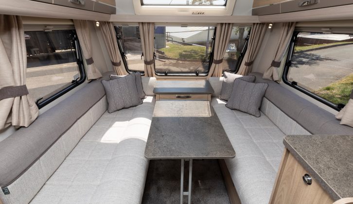 The comfortable front lounge in the 2019 Elddis Avanté 586 pictured with the folding leg table in position for mealtimes