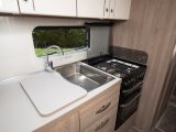 The Compass Camino 674's kitchen comes with a dual-fuel cooker, for maximum flexibility on tour, a separate oven and grill and a sink with smart mixer tap