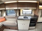 The midships kitchen in the new Bailey Pegasus Grande Brindisi has a dual-fuel cooker. separate oven and grill, a pair of plug sockets and plenty of storage