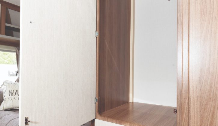 Clothes storage provision majors on the half-length offside wardrobe with drawers underneath