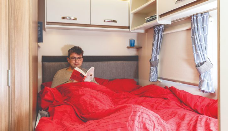 The rear corner bed has a supportive headboard and handy shelves up above