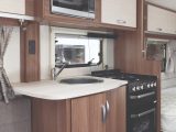 The well-planned kitchen has a four-burner dual fuel hob, oven and a Russell Hobbs microwave; far more than you'd expect from an entry-level van