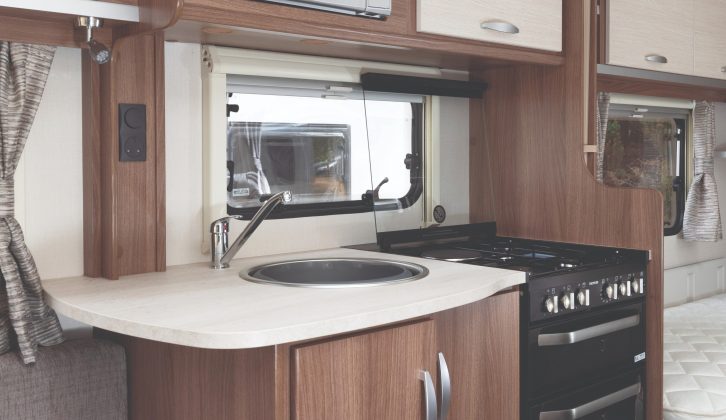 The well-planned kitchen has a four-burner dual fuel hob, oven and a Russell Hobbs microwave; far more than you'd expect from an entry-level van