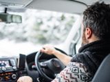 Man driving car in wintry conditions