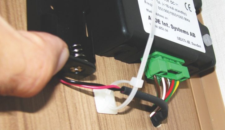 Attach the cable tie to the internal panel and the double-sided tape to the battery holder