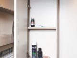 The washroom has two shelved cupboards and open shelving for all of those lotions and potions