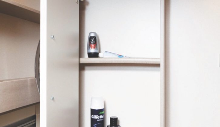 The washroom has two shelved cupboards and open shelving for all of those lotions and potions