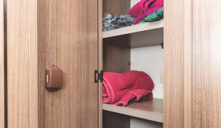 This very sizeable shelved cupboard is within the washroom and includes a laundry bag
