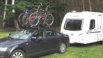 Roof-mounted bike carriers are attached to the roof rails on your tow car