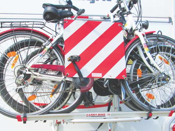 Some countries require you to display this warning sign on protruding loads, such as bikes