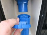 Insert the blue connector with the recessed tubes (female end) into your caravan's input socket