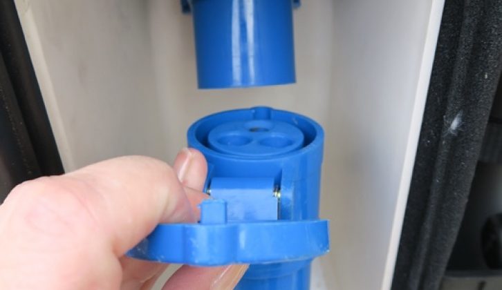 Insert the blue connector with the recessed tubes (female end) into your caravan's input socket