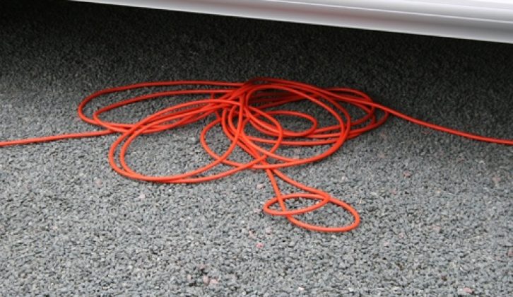 Completely unwind the hook-up cable to avoid any risk of it overheating and possibly catching fire, and place it carefully underneath the caravan