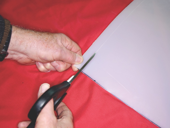 Using sharp scissors or shears, cut along the marked line