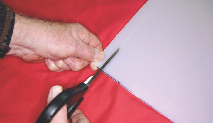 Using sharp scissors or shears, cut along the marked line
