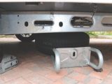 Lower the spare wheel carrier and swing it slightly towards the rear of the caravan to provide better access