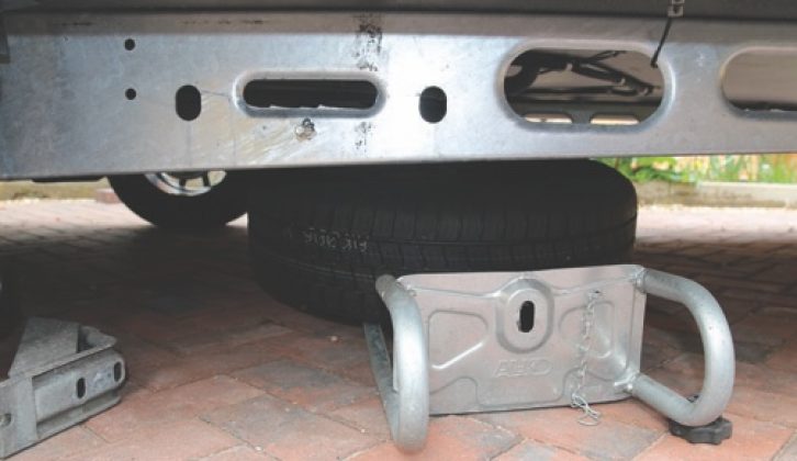 Lower the spare wheel carrier and swing it slightly towards the rear of the caravan to provide better access