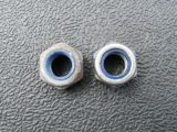 Use new Nylock nuts (used ones on the left, new on the right)