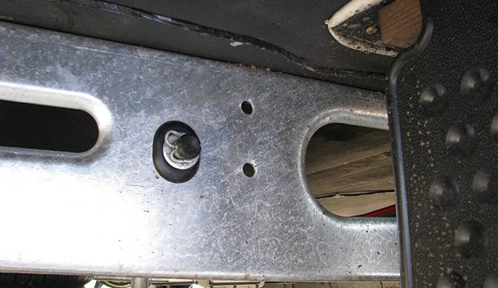 Locate the pre-punched holes on each side of the caravan