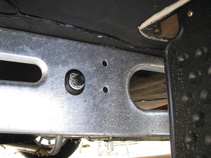 Locate the pre-punched holes on each side of the caravan