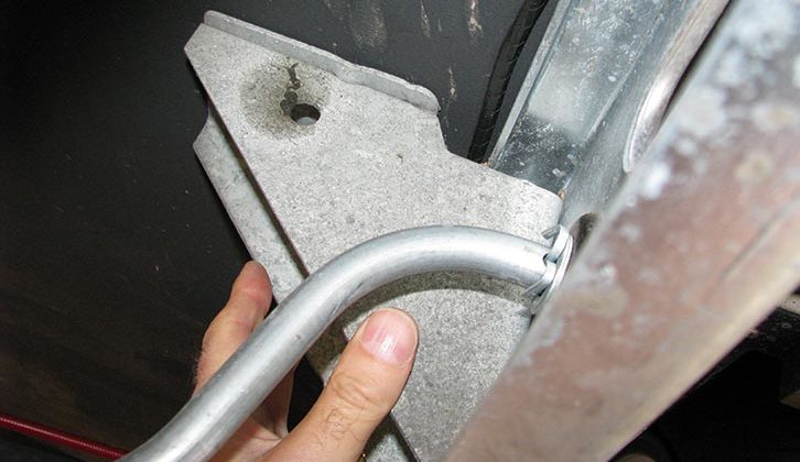 Position the inner jack mounting bracket over the pre-punched holes, or insert the bolts (and washers) through the holes in the bracket