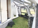 A tailored air awning wraps around the van